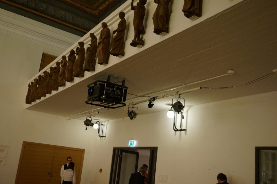 Video Projector Casting Images onto the Ceiling-Mounted Disc in the Mozart House Lounge